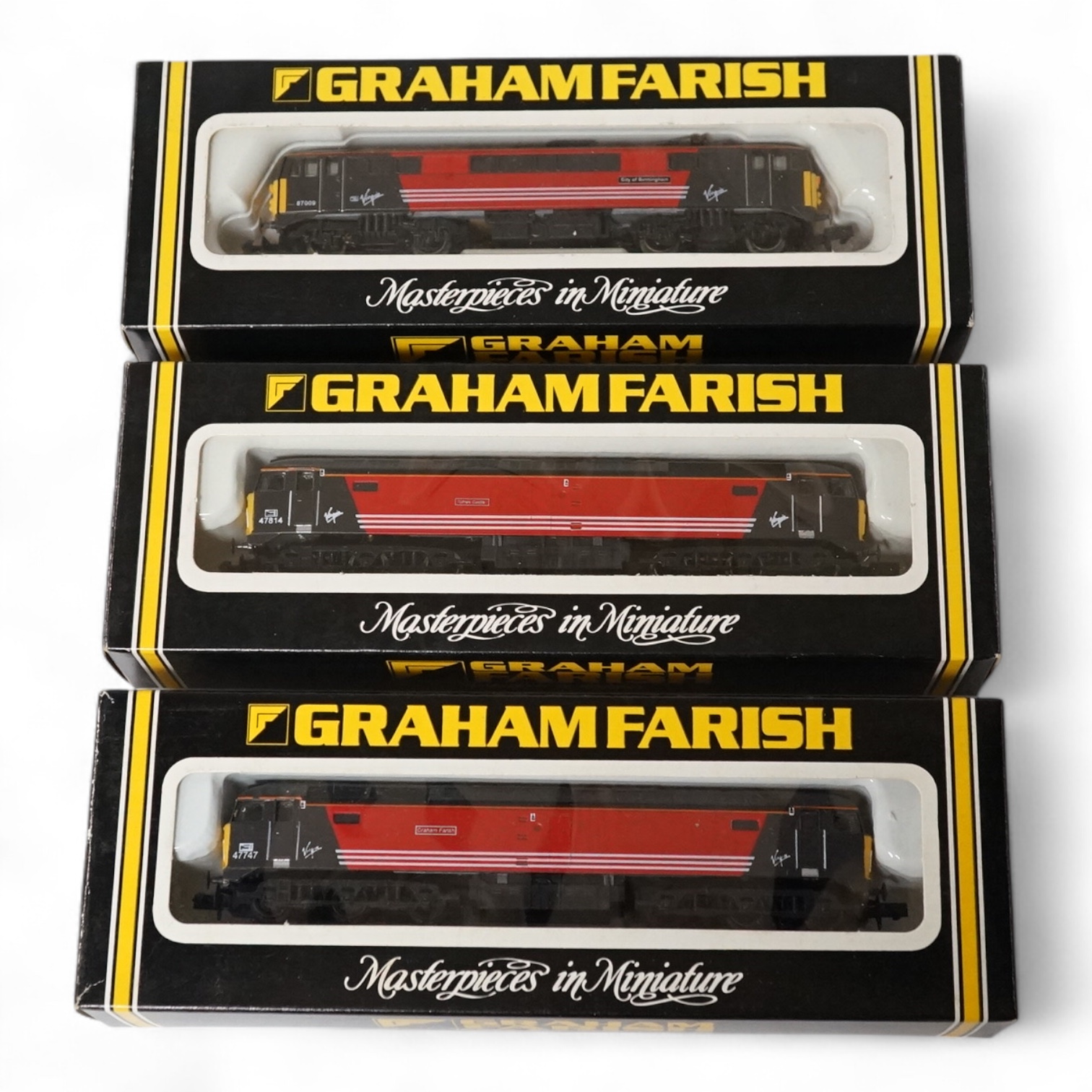 Three boxed Graham Farish N gauge railway locomotives in Virgin Trains livery; a class 47 Graham Farish 47747 (FA80211), a class 47 Totnes Castle 47814 (800A), and a class 87 City of Birmingham 87009 (883A). Condition -